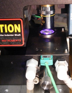 Nanoindenter with laser heater